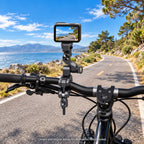 Multi-joint clamp on a stationary bicycle with camera lens pointing forward; camera and bicycle not included