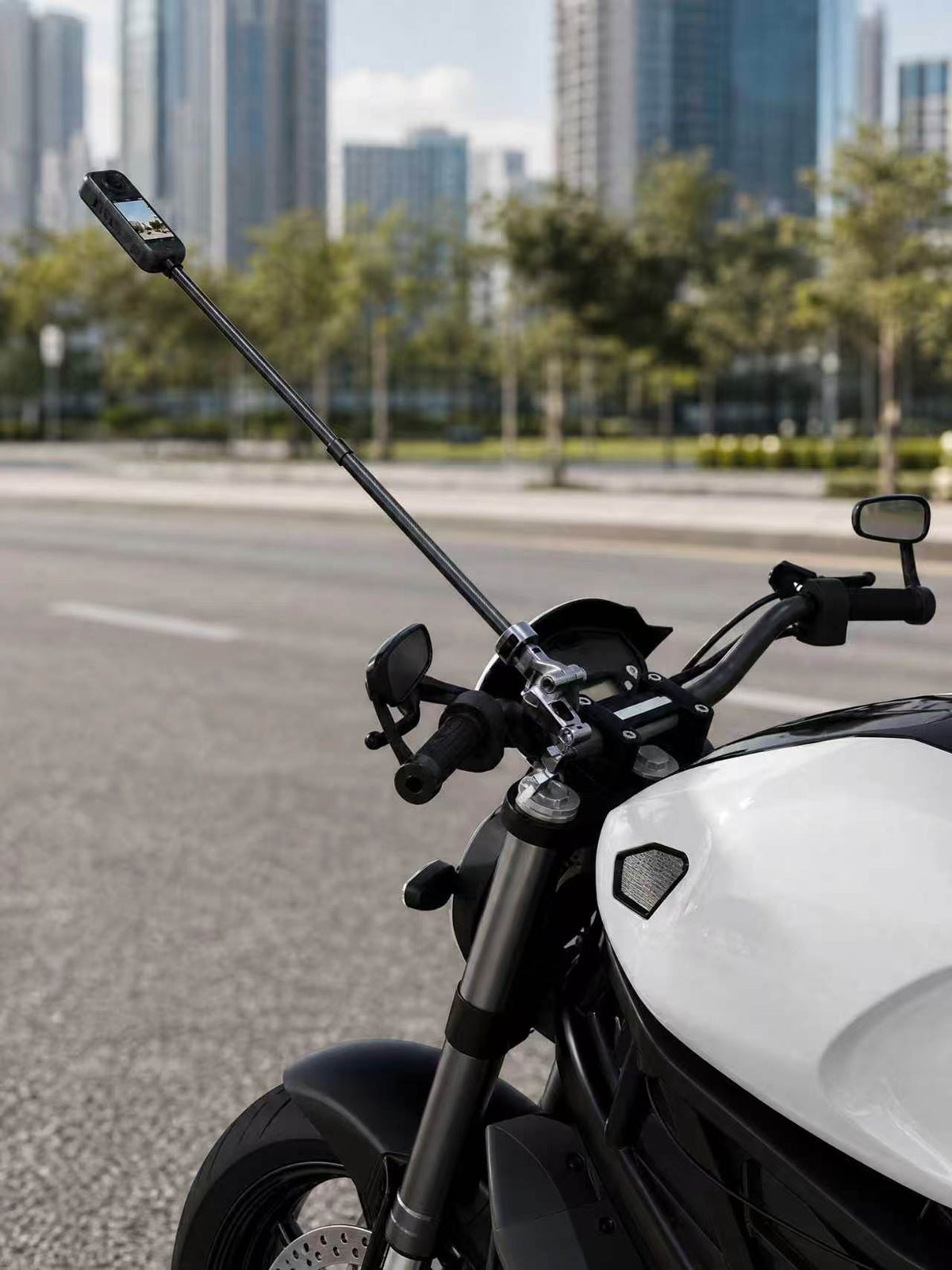 FLW153 extension pole with the separately sold multi-joint clamp in a stationary motorcycle setup; camera, clamp and motorcycle not included