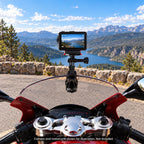 Windshield clip setup on a parked motorcycle with forward-facing camera; camera and adapter not included